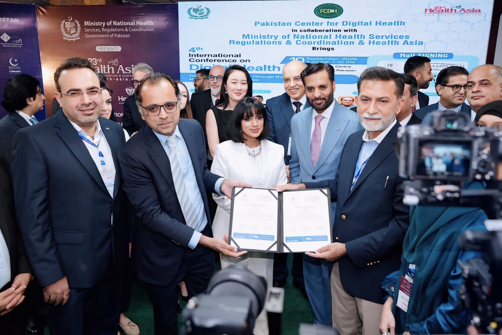 NeuroCheck Pro representatives with conference dignitaries and press after an award presentation at Health Asia 2026