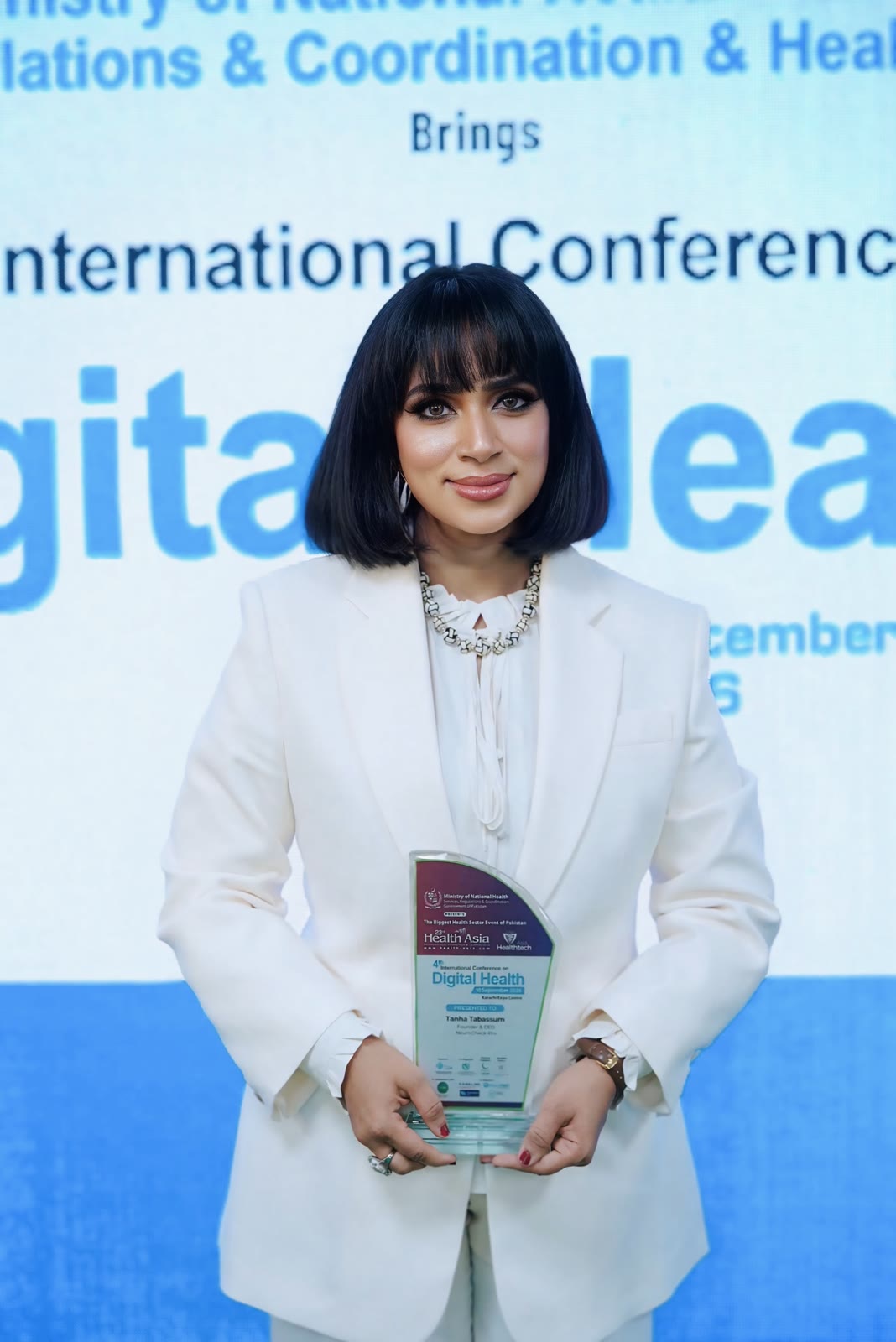 Tanha Tabassum receiving an award on stage at the International Conference on Digital Health