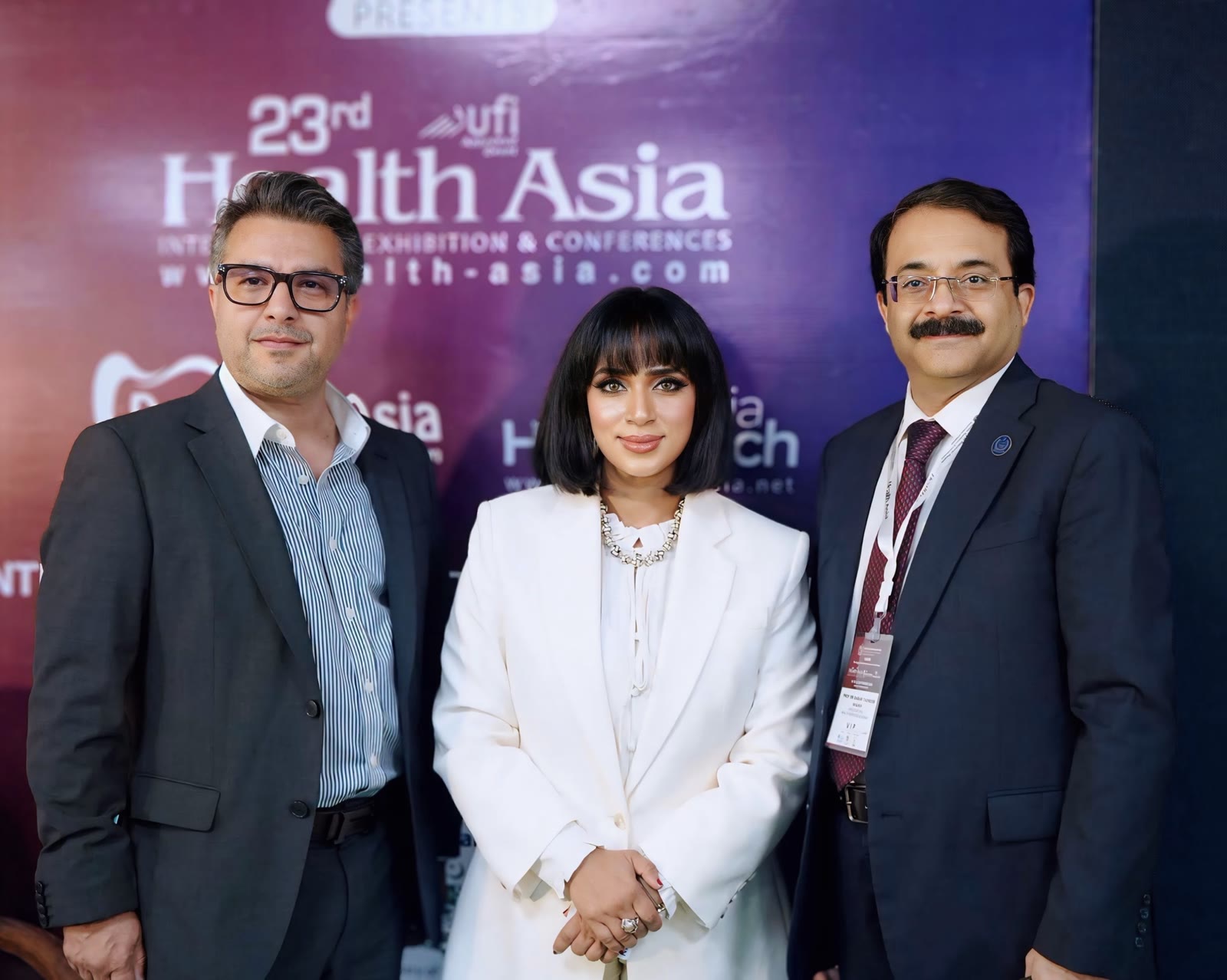 Tanha Tabassum with delegates at the 23rd Health Asia backdrop